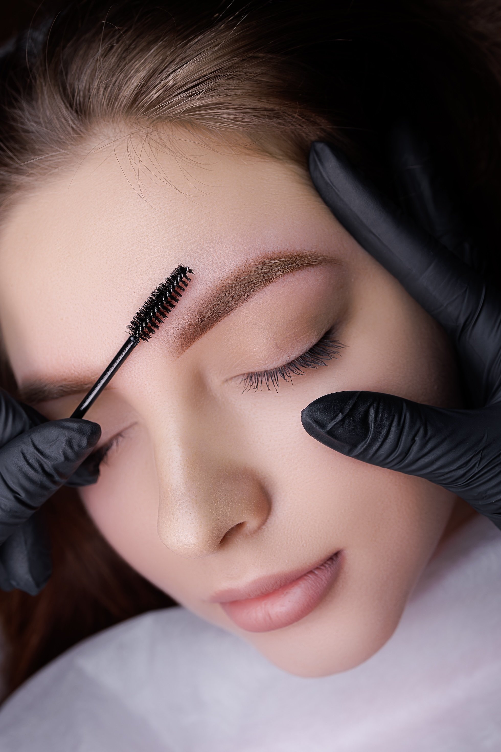Woman receiving an eyebrow treatment